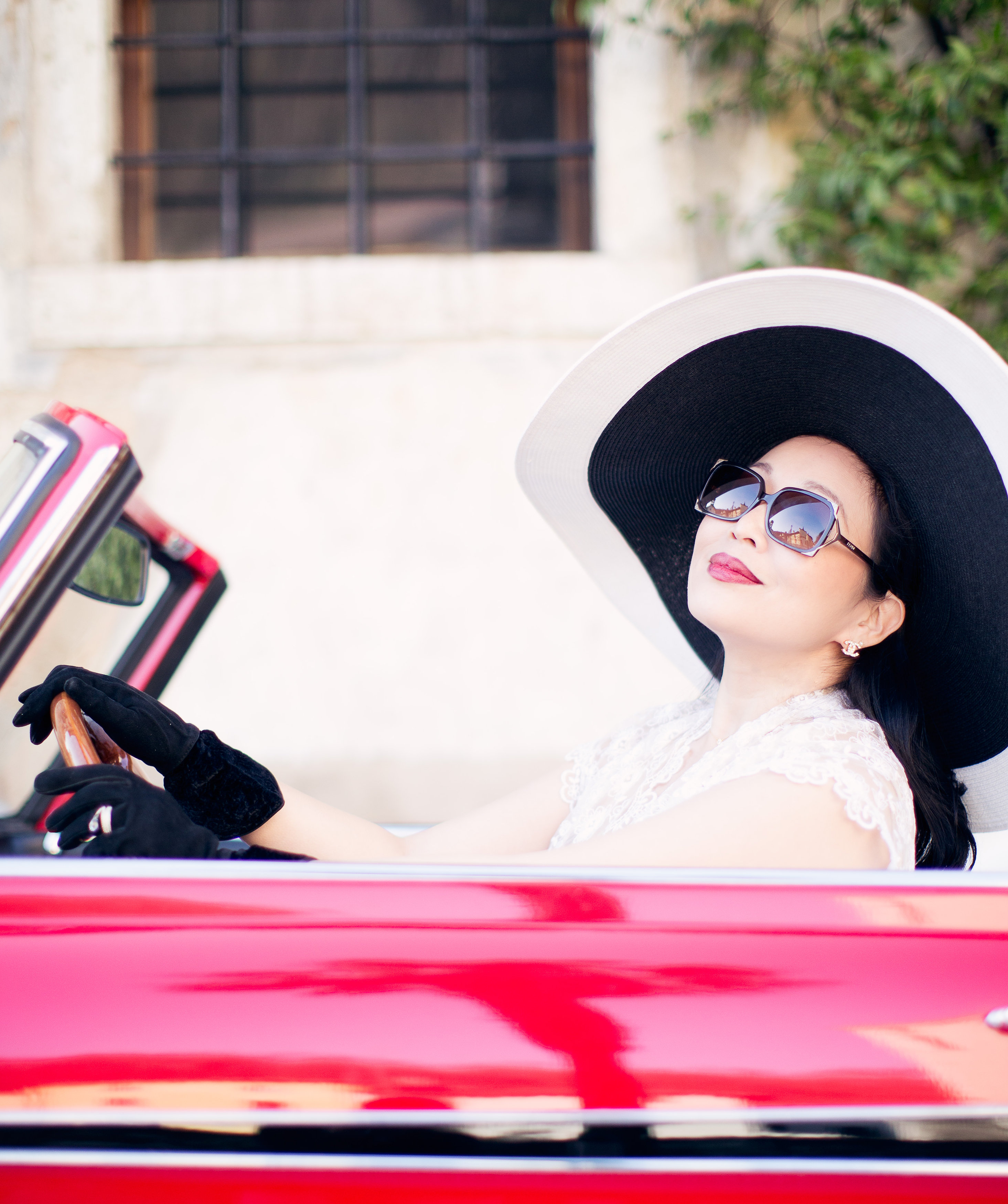 Charlene Chi in red antique car